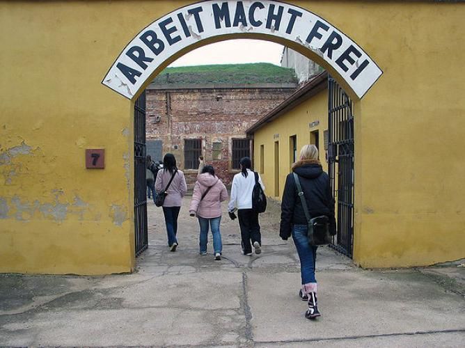 From Prague: Terezin Concentration Camp Private Tour - Entering the Main Gate: ARBEIT MACHT FREI and the Moment It Hits