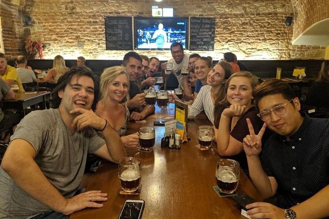 Old Prague pubs tour. Beer and dinner included! - Crossing Charles Bridge: Prague in motion, with beer in hand