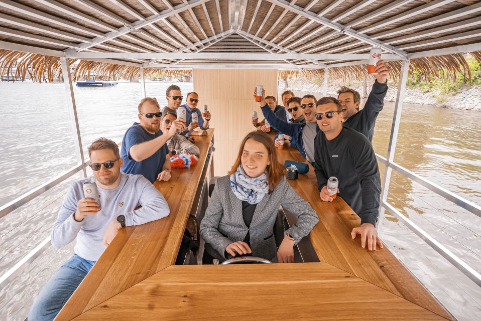 Prague: Party Tiki Boat Sightseeing Cruise with Drinks - The onboard setup: tabletop seating and English guide commentary